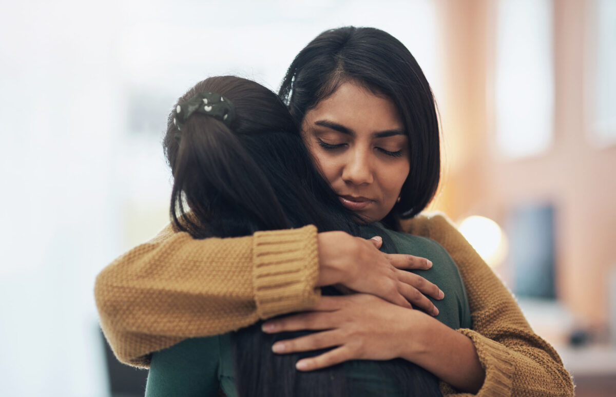 Friends, Hug And Support Of Women Together In A House With Love, Care And Empathy. Indian Sisters Or Female Family In A Room While Sad, Depressed And Hugging For Comfort, Trust And Quality Time