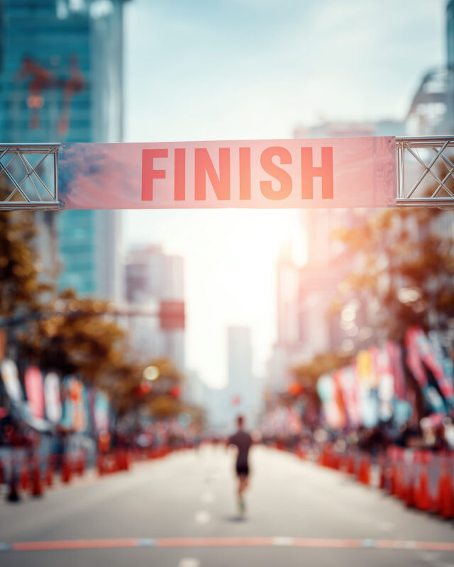 Marathon Finish Line Banner On City Street With Blurred Runner A