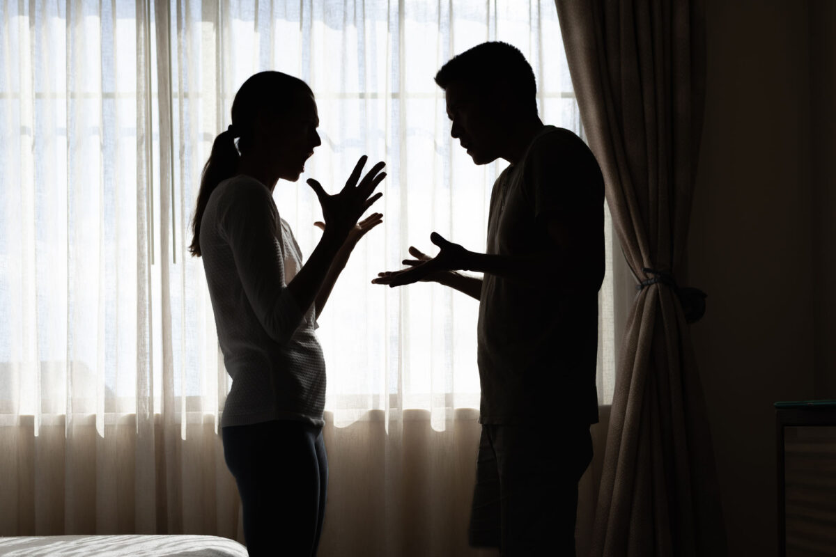 Silhouette Of A Young Couple Arguing Fighting At Home, Family Is